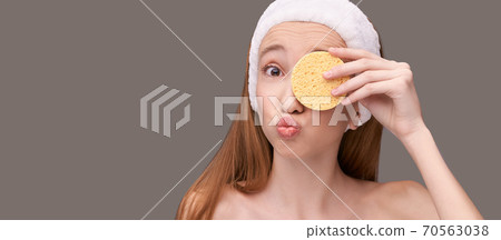 Young beauty girl remove mascara. Face sponge cleaner 70563038