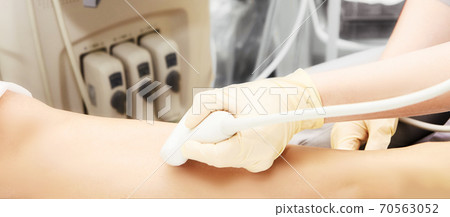 Doctor ultrasound knee test. Scan medical equipment. Diagnosis ultrasound foot 70563052