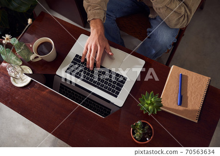 Top view red head worker with laptop sitting at table 70563634