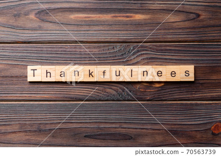 Thankfulness word written on wood block. Thankfulness text on cement table for your desing, concept Thankfulness word written on wood block. Thankfulness text on cement table for your desing, concept 70563739