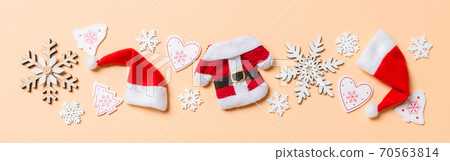 Top view Banner of Christmas decorations and Santa hats on orange background. Happy holiday concept with copy space 70563814