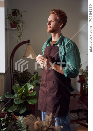 Portrait of florist drinking tasty coffee Portrait of florist drinking tasty coffee 70564159