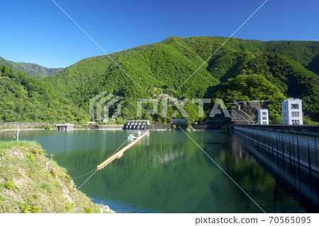 Lake Okutama in summer, from the south shore to the lake surface and the mountains on the north shore Lake Okutama in summer, from the south shore to the lake surface and the mountains on the north shore 70565095