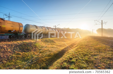 Moving freight train in fog at sunrise in autumn. Industrial 70565362