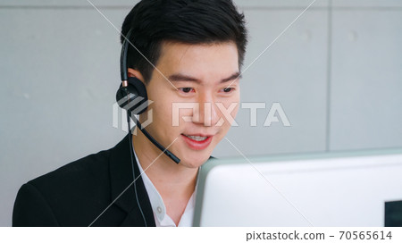 Business people wearing headset working in office Business people wearing headset working in office 70565614