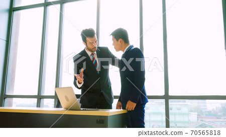Two business people talk project strategy at office Two business people talk project strategy at office 70565818