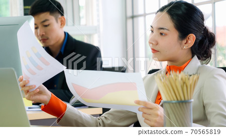 Business people working at table in modern office Business people working at table in modern office 70565819