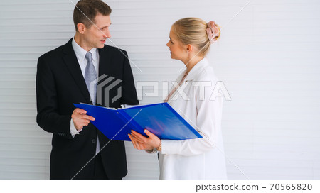Two business people talk project strategy at office Two business people talk project strategy at office 70565820