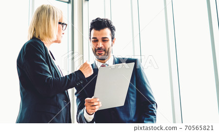 Two business people talk project strategy at office Two business people talk project strategy at office 70565821