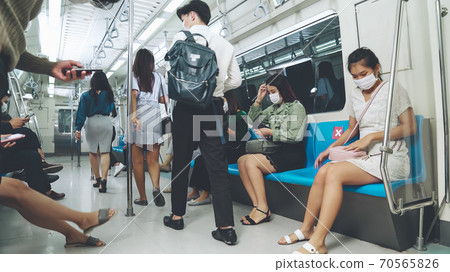 Crowd of people wearing face mask on a crowded public subway train travel Crowd of people wearing face mask on a crowded public subway train travel 70565826