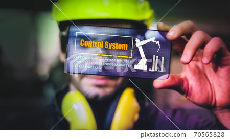 Factory worker use future holographic screen device to control manufacturing Factory worker use future holographic screen device to control manufacturing 70565828