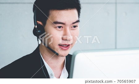 Business people wearing headset working in office 70565907