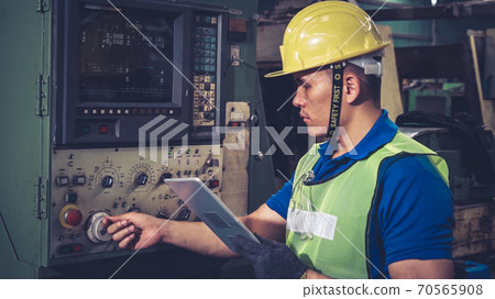 Smart factory worker using machine in factory workshop 70565908
