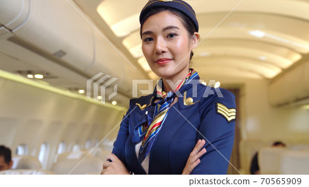 Cabin crew or air hostess working in airplane Cabin crew or air hostess working in airplane 70565909