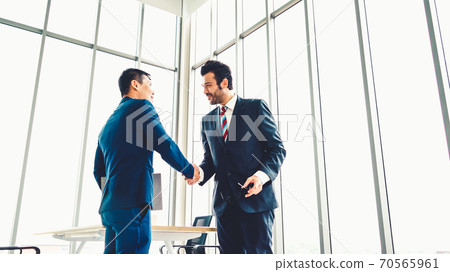 Business people handshake in corporate office Business people handshake in corporate office 70565961