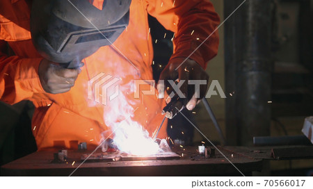 Metal welder working with arc welding machine Metal welder working with arc welding machine 70566017