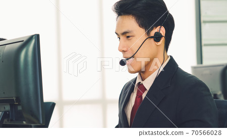 Business people wearing headset working in office 70566028