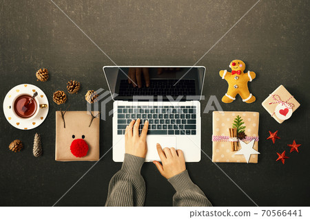 Christmas giftboxes with person using a laptop computer 70566441