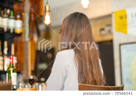 A woman relaxing at the bar 70566541