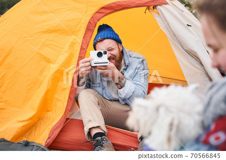 Man taking pictures on the polaroid Man taking pictures on the polaroid 70566845