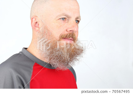 portrait of a bearded man on a light background 70567495
