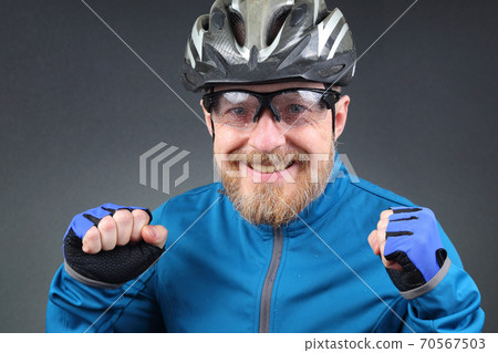 bearded cyclist rejoices at victory. bearded cyclist rejoices at victory. 70567503