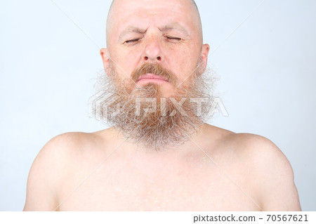 portrait of a bearded man on a light background portrait of a bearded man on a light background 70567621