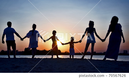 Silhouette of family on sunset background Silhouette of family on sunset background 70567626