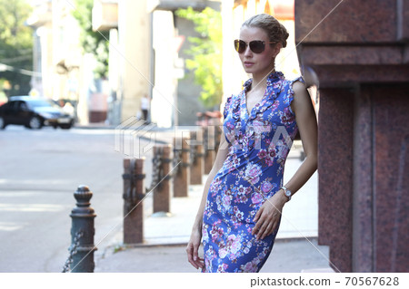 slender young beautiful girl standing near the wall of the building slender young beautiful girl standing near the wall of the building 70567628