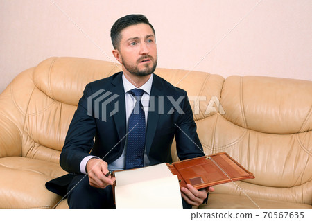 successful business man with business documents 70567635