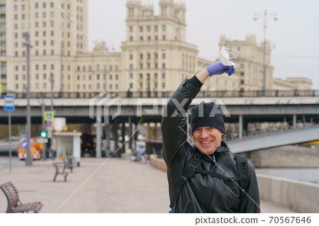 Man does not wearing protective mask outdoors. Coronavirus pandemic time. Man does not wearing protective mask outdoors. Coronavirus pandemic time. 70567646