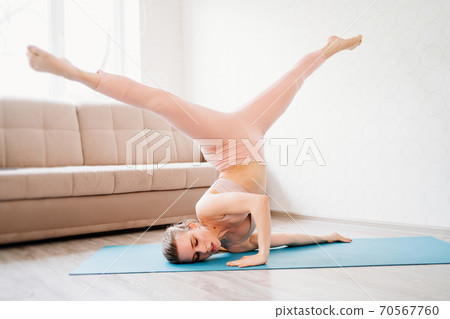 athlete girl is engaged in gymnastics.acrobat home athlete girl is engaged in gymnastics.acrobat home 70567760