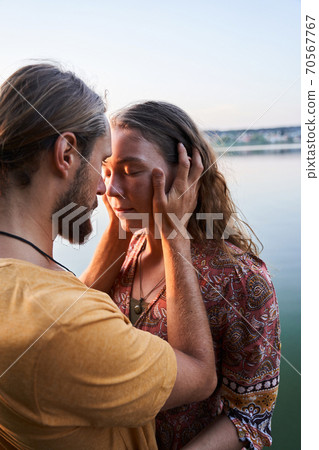Man hugging his girlfriend Man hugging his girlfriend 70567767