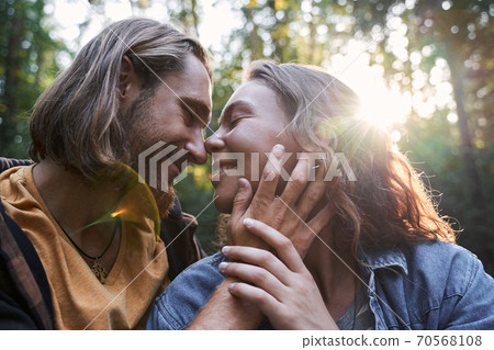 Couple together admiring the sunset Couple together admiring the sunset 70568108
