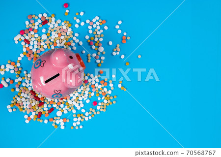 concept for medical expenses, Tablets and piggy bank on blue background 70568767