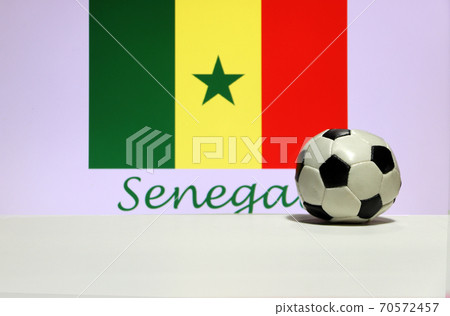 Small football on the white floor and Senegalese nation flag with the text of Senegal background. Small football on the white floor and Senegalese nation flag with the text of Senegal background. 70572457