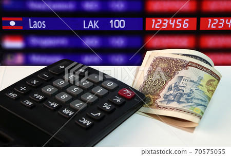 Five hundreds of banknote currency Lao Kip with calculator on the white floor Five hundreds of banknote currency Lao Kip with calculator on the white floor 70575055