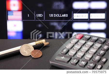 Coin of United stage of America with calculator and pencil on black floor with digital board Coin of United stage of America with calculator and pencil on black floor with digital board 70575075