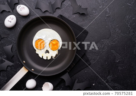 Fried eggs in the shape of a skull. Halloween breakfast. Fried eggs in the shape of a skull. Halloween breakfast. 70575281