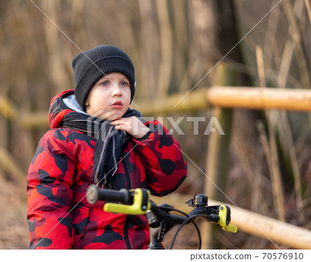 Angry boy on bicycle at park 70576910