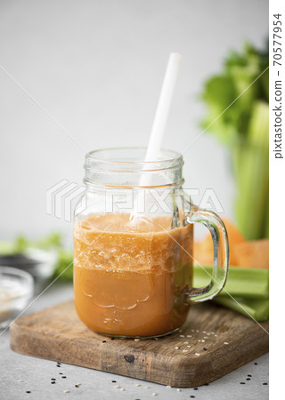 carrot and celery vegetable smoothie with sesame seeds 70577954