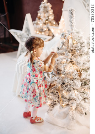 Smiling lovely baby girl in cute dress with lots Smiling lovely baby girl in cute dress with lots 70580318