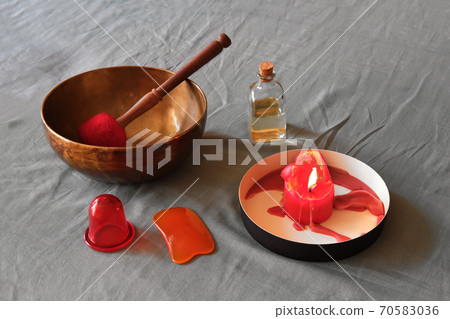 Massage items: oil, singing bowl, vacuum can and scented candle on textile linen background 70583036
