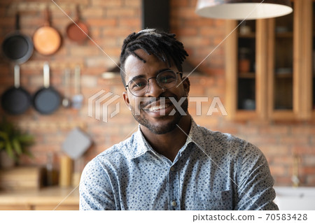 Headshot portrait of smiling African American man in glasses Headshot portrait of smiling African American man in glasses 70583428