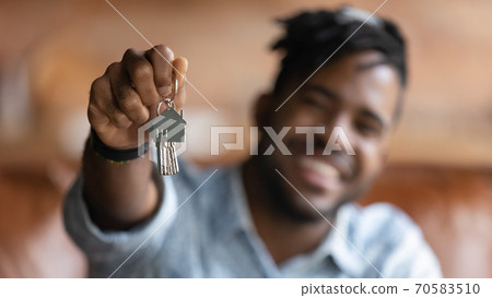 Close up of male renter show house keys 70583510