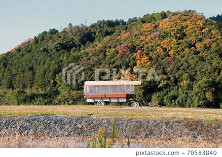 The trailer on the grassy hill and background mountain range with blue sky. 70583840