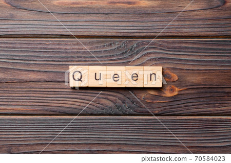 queen word written on wood block. queen text on cement table for your desing, concept 70584023