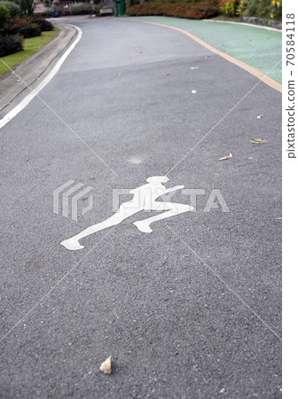 The white jogging man painting on the jogging lane parallel with green bike lane. 70584118