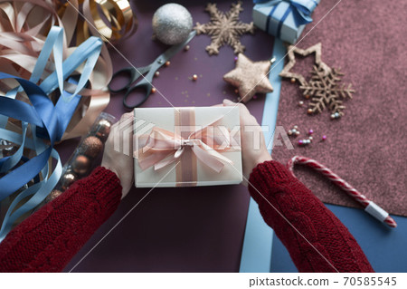 Hands holding present for Christmas Hands holding present for Christmas 70585545