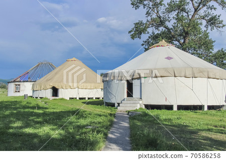 A row of traditional constructed yurts in Kalajun Grassland, Xinjiang, China A row of traditional constructed yurts in Kalajun Grassland, Xinjiang, China 70586258